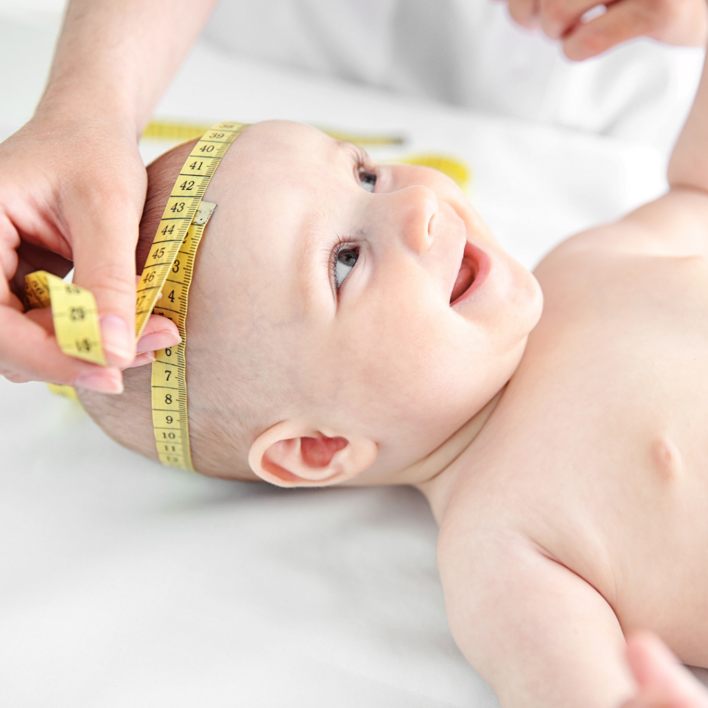 Baby having their head circumference measured with a measuring tape.