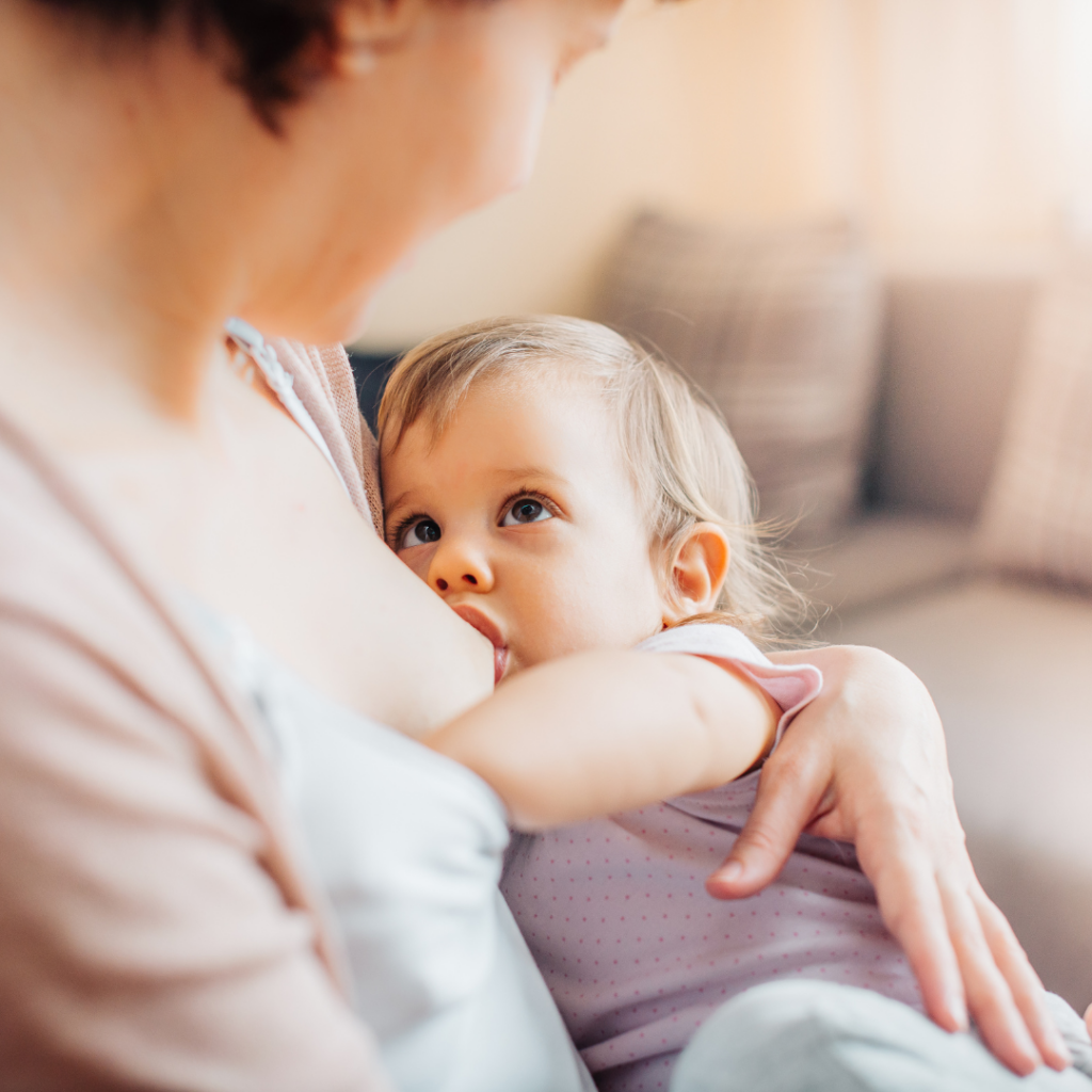 A mother nurses her baby, providing more breast milk for them.