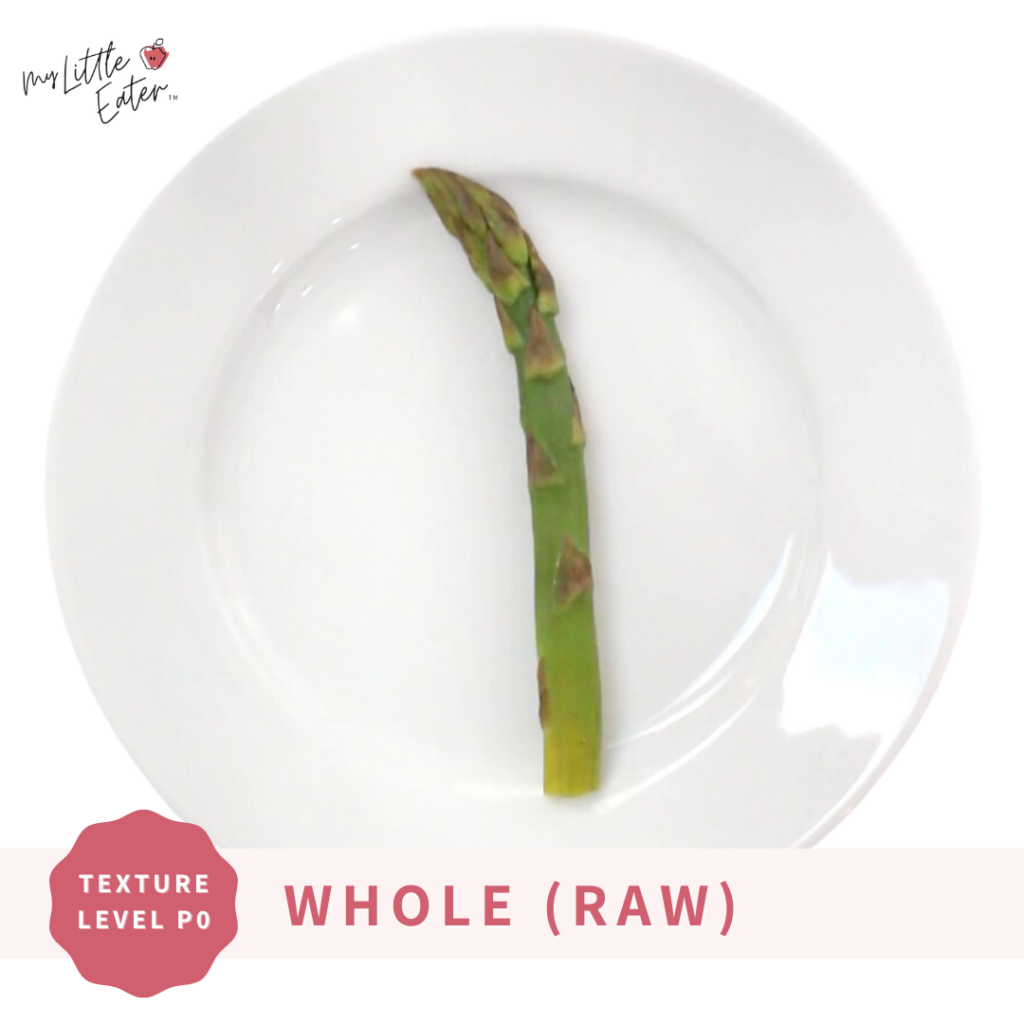 Whole, raw asparagus spear on a plate to introduce asparagus to babies.