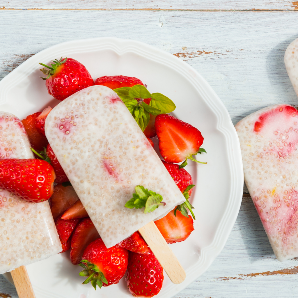 Milk popsicle with seeds and strawberries.