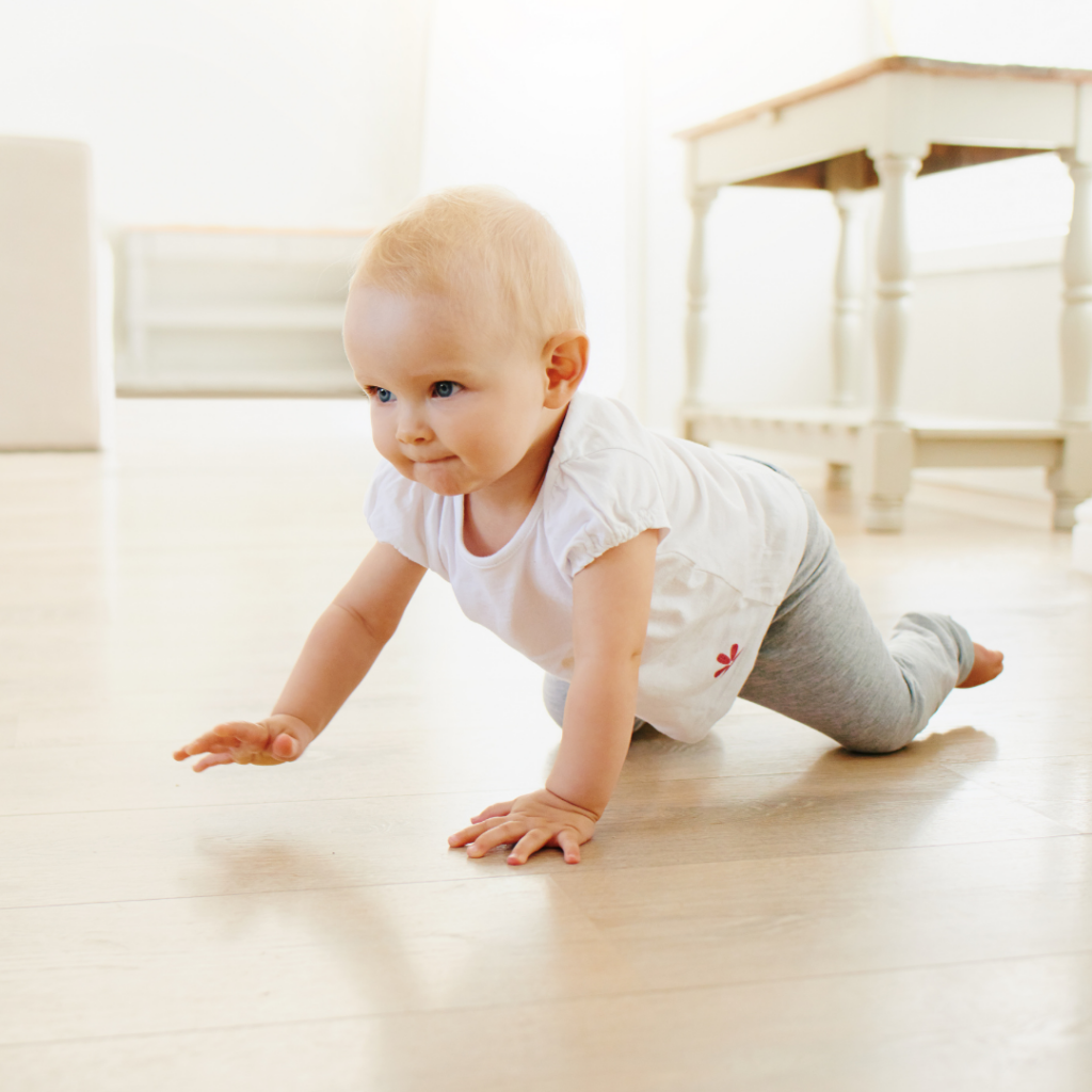 Baby crawls across the floor.