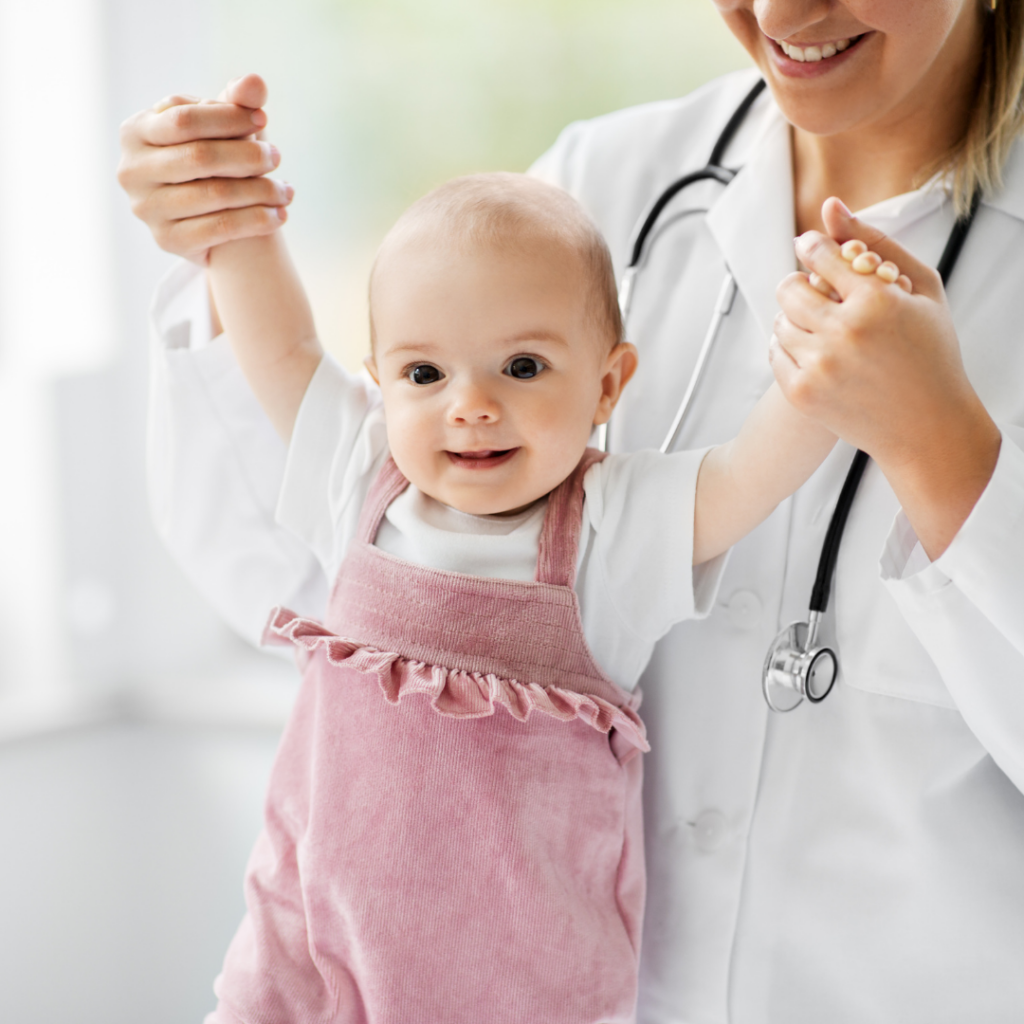 Baby with a doctor for a well-baby check to determine baby weight and if following typical growth patterns.