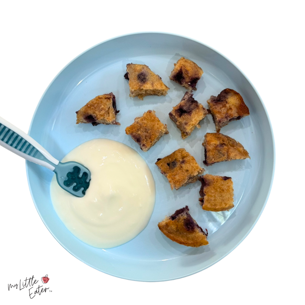 Pancake pieces made from pancake freezer pucks on a baby plate with yogurt.