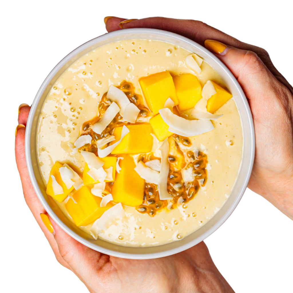 Tropical smoothie bowl topped with mango, coconut and passionfruit.