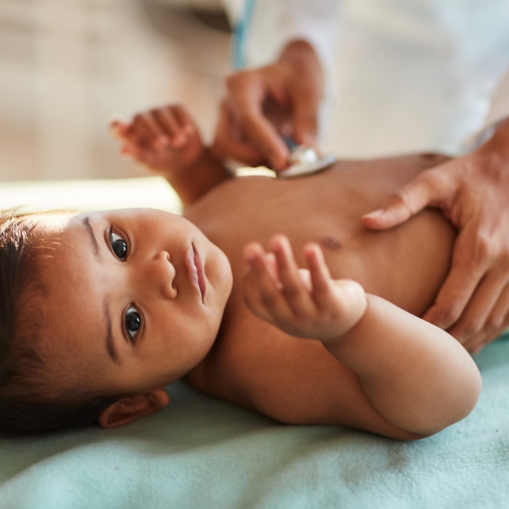 Baby at a checkup with their doctor undergoing a routine exam.