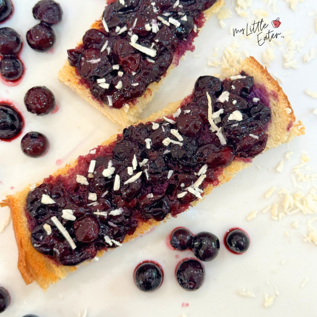 Toast with mashed blueberries and shredded coconut.