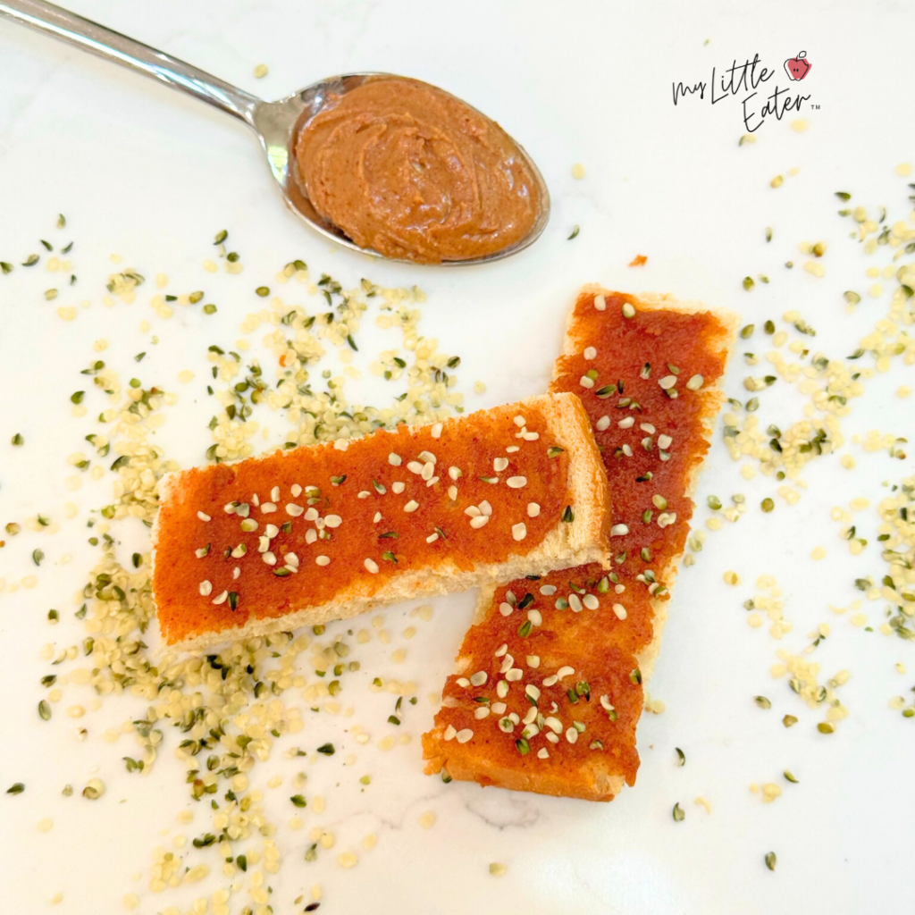 Toast with a thin layer nut butter and hemp seeds for baby led weaning.