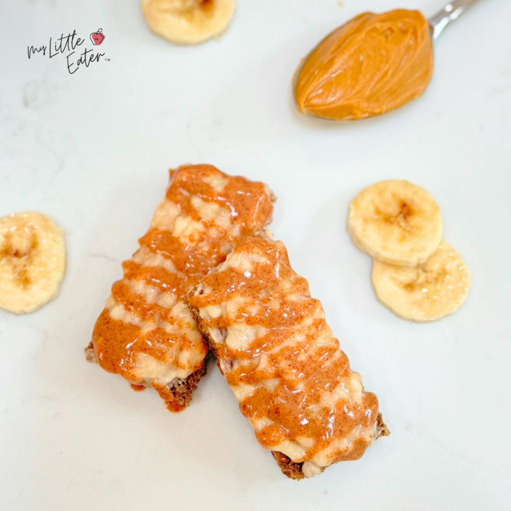 Toast for babies with mashed banana and drizzled nut butter.