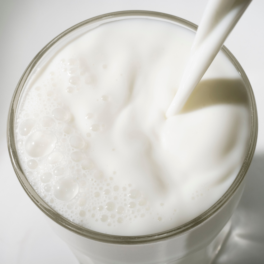 Overhead view of a tall glass of vitamin d fortified milk.