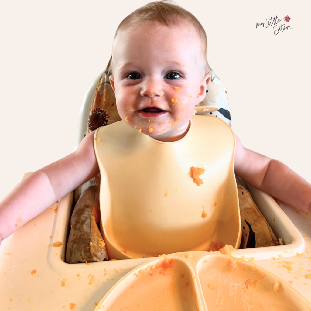 Baby eating butternut squash puree.