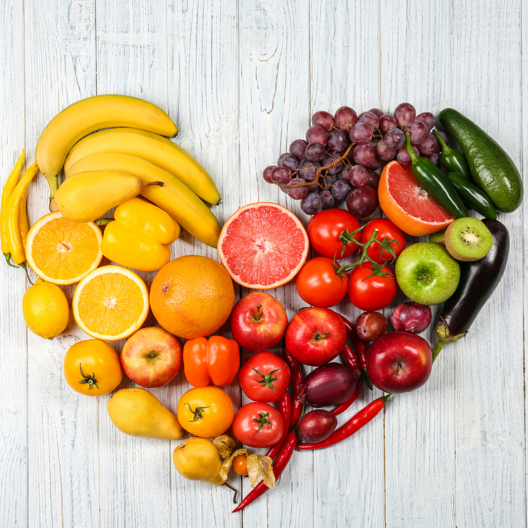 Various fruits and vegetables as part of a healthy diet for immune health are arranged in a heart shape.