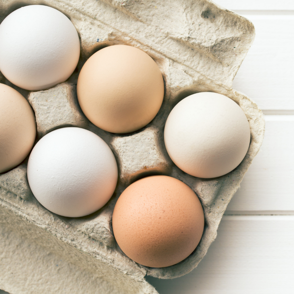 A carton of brown and white eggs.