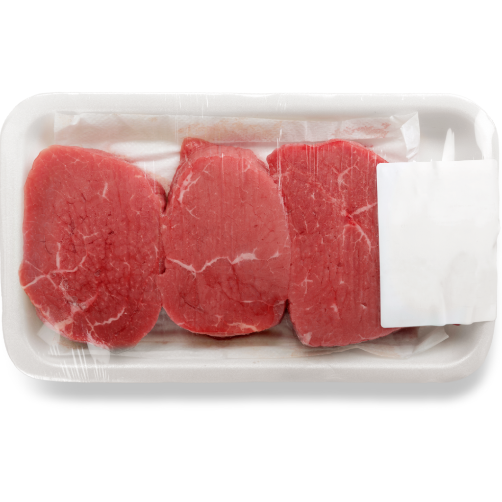 Three raw steaks in a grocery store plastic package.