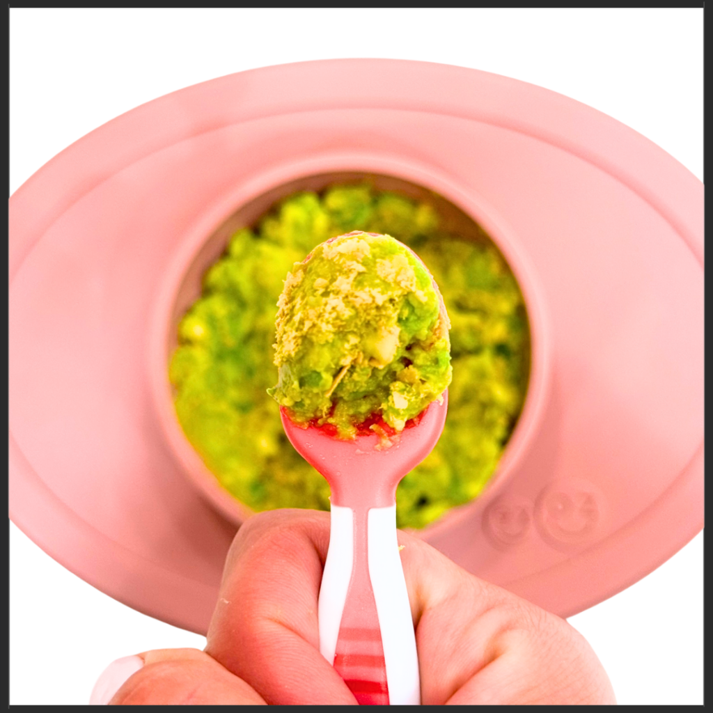 Mashed avocado and nutritional yeast preloaded on a baby spoon for a low sodium intake option.