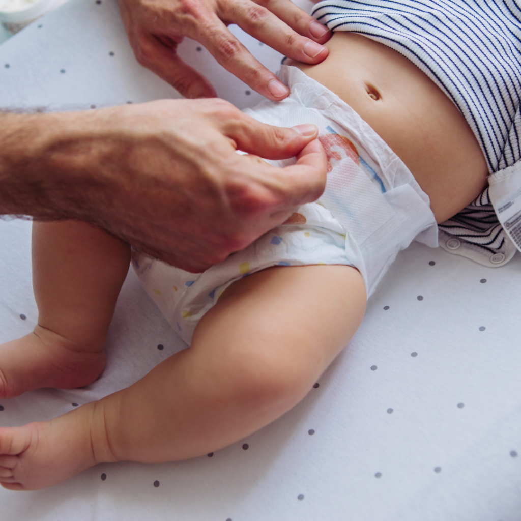 A parent changes their baby's diaper.