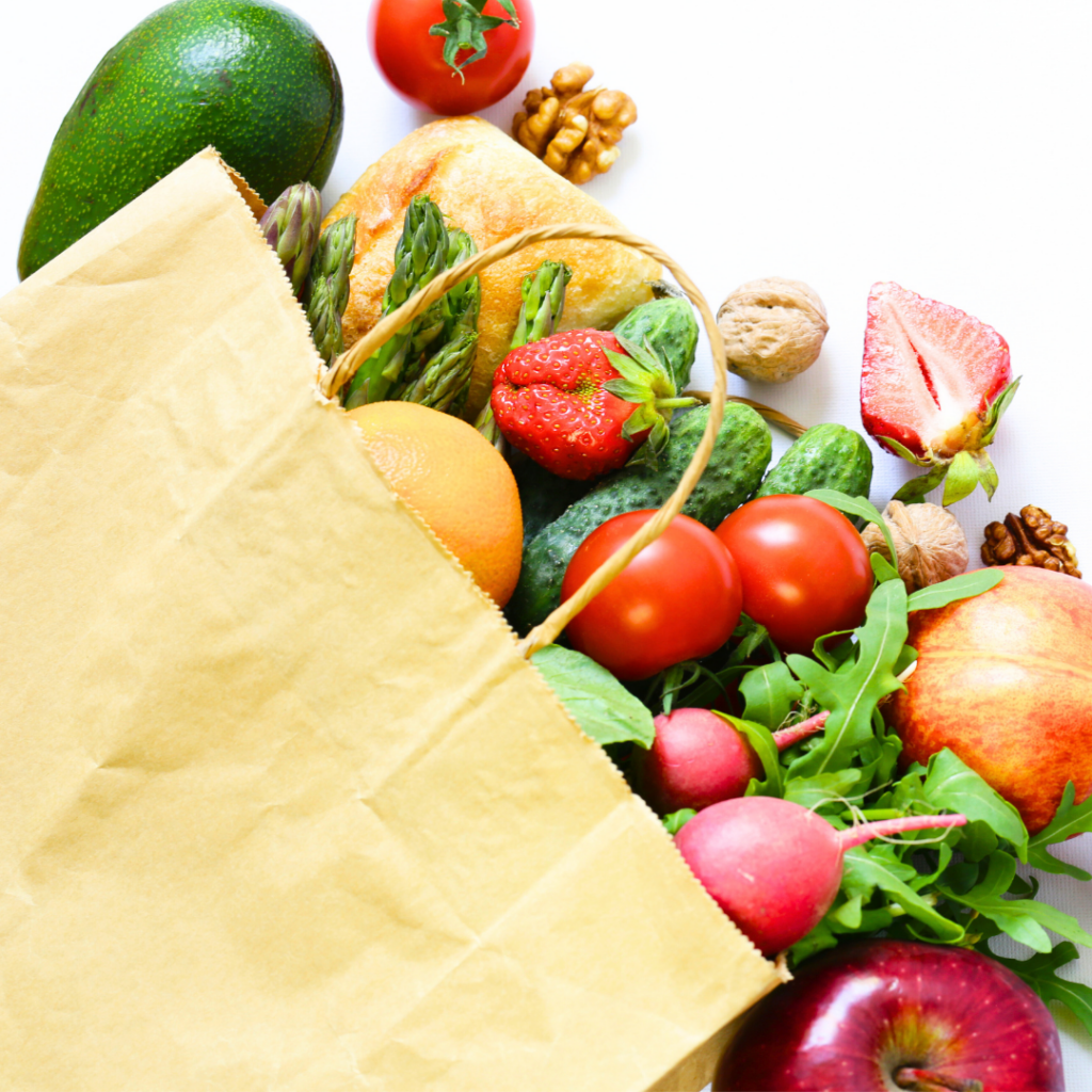 A grocery bag of fresh fruits and vegetables as part of a normal sodium diet.