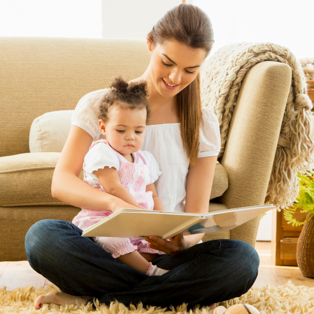 Mom with her baby on her lap while they look through a book.