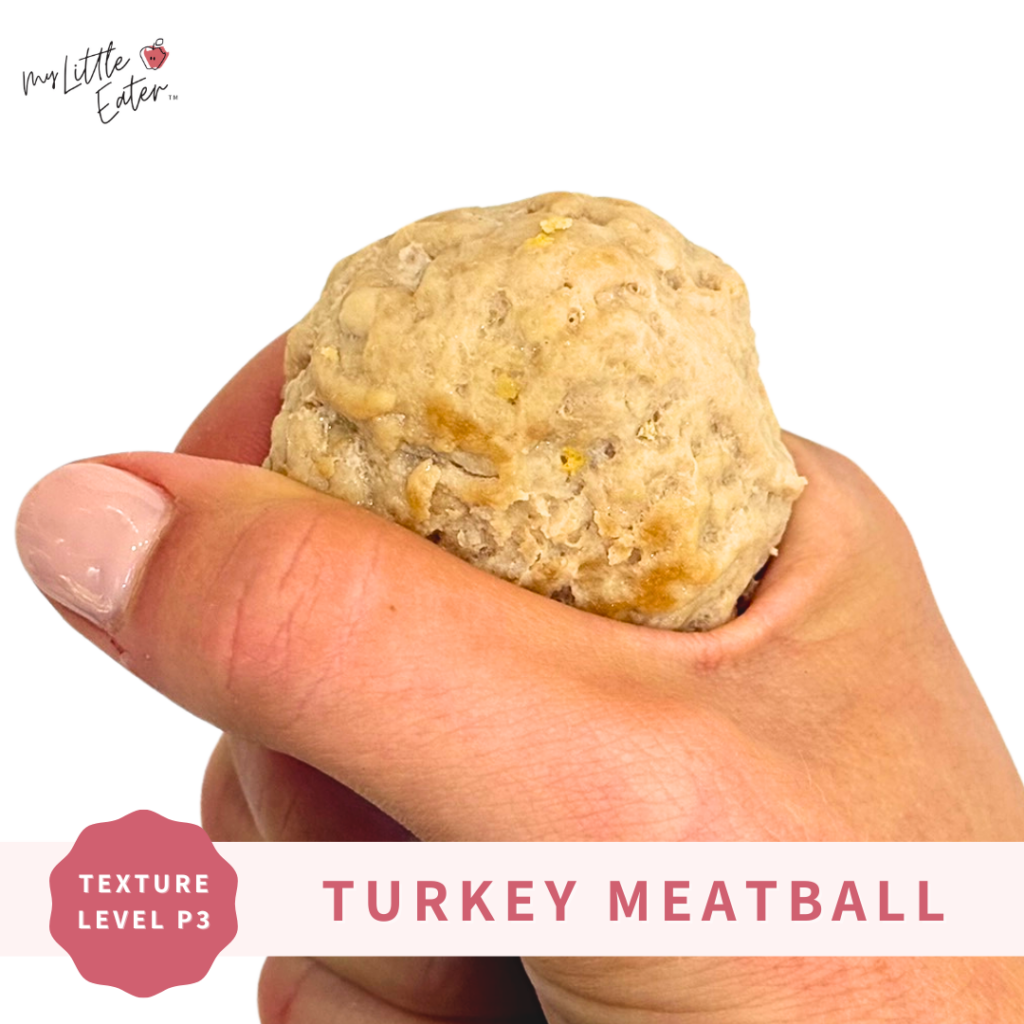 A turkey meatball to be offered alongside cooked veggies for baby and the whole family.