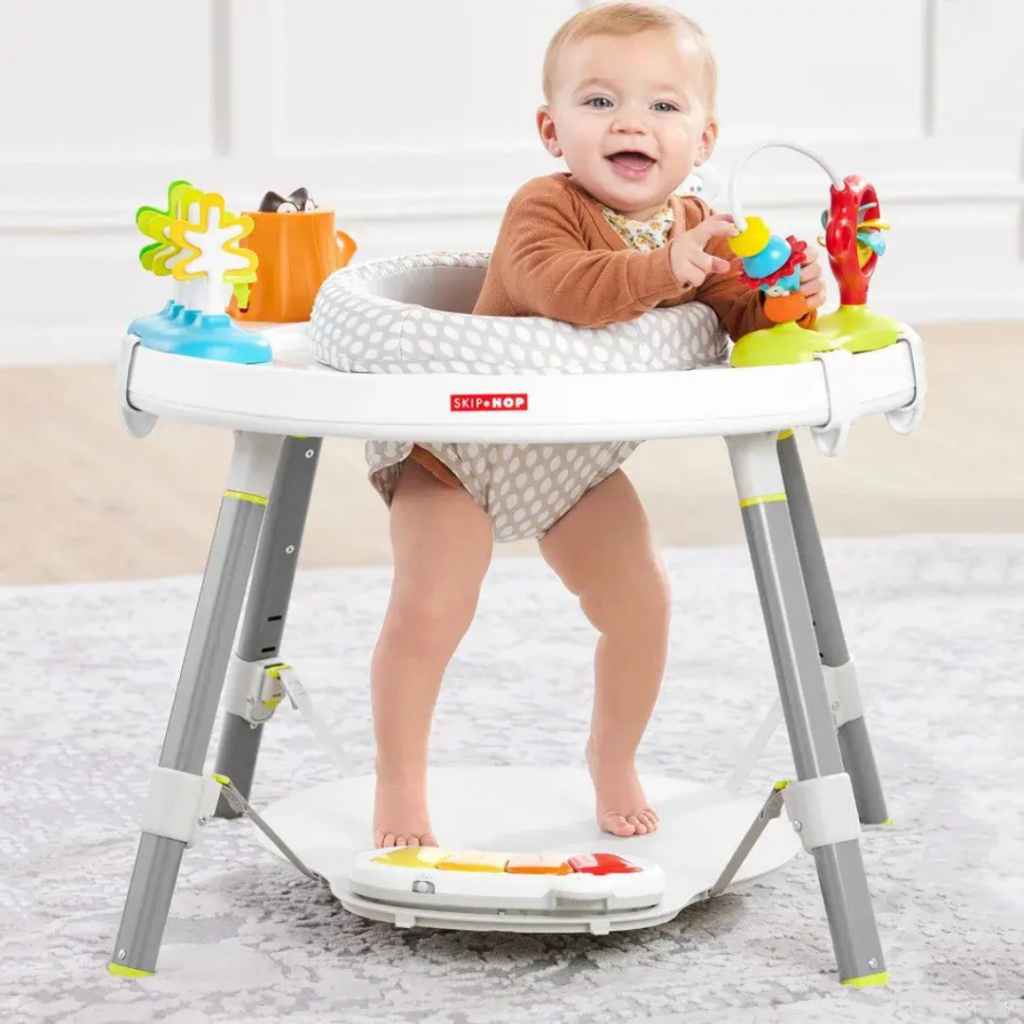 Baby in a Skip Hop activity table.