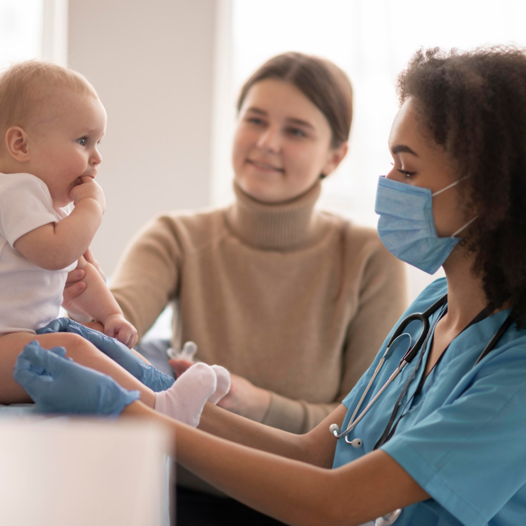 Doctor wearing a mask examines a baby that recently started solid foods.