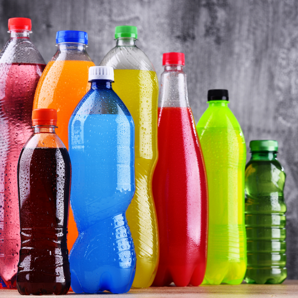 Pops and sports drinks in different sized bottles, all of different colors.