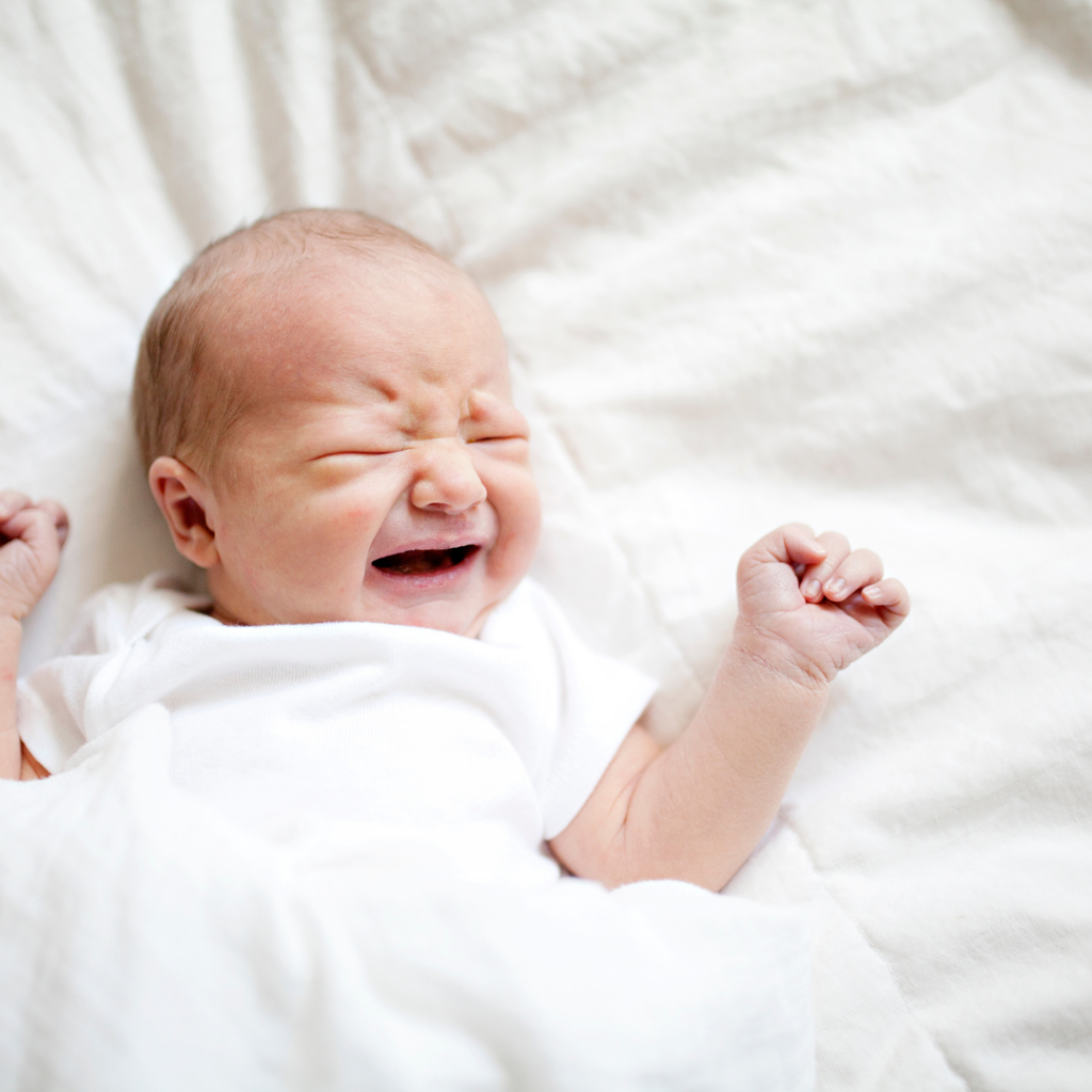 Baby appears in discomfort while lying down.