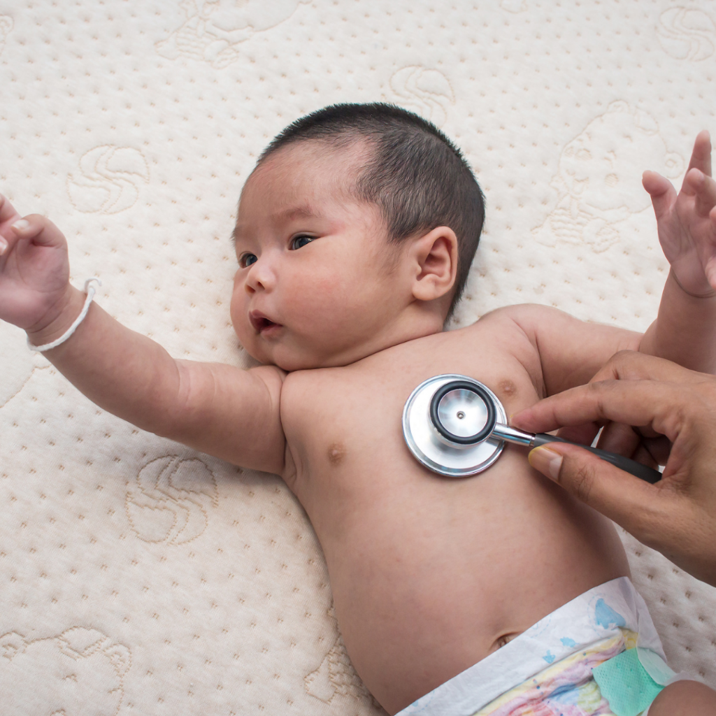 A doctor listens to a baby's heartbeat with a stethoscope.