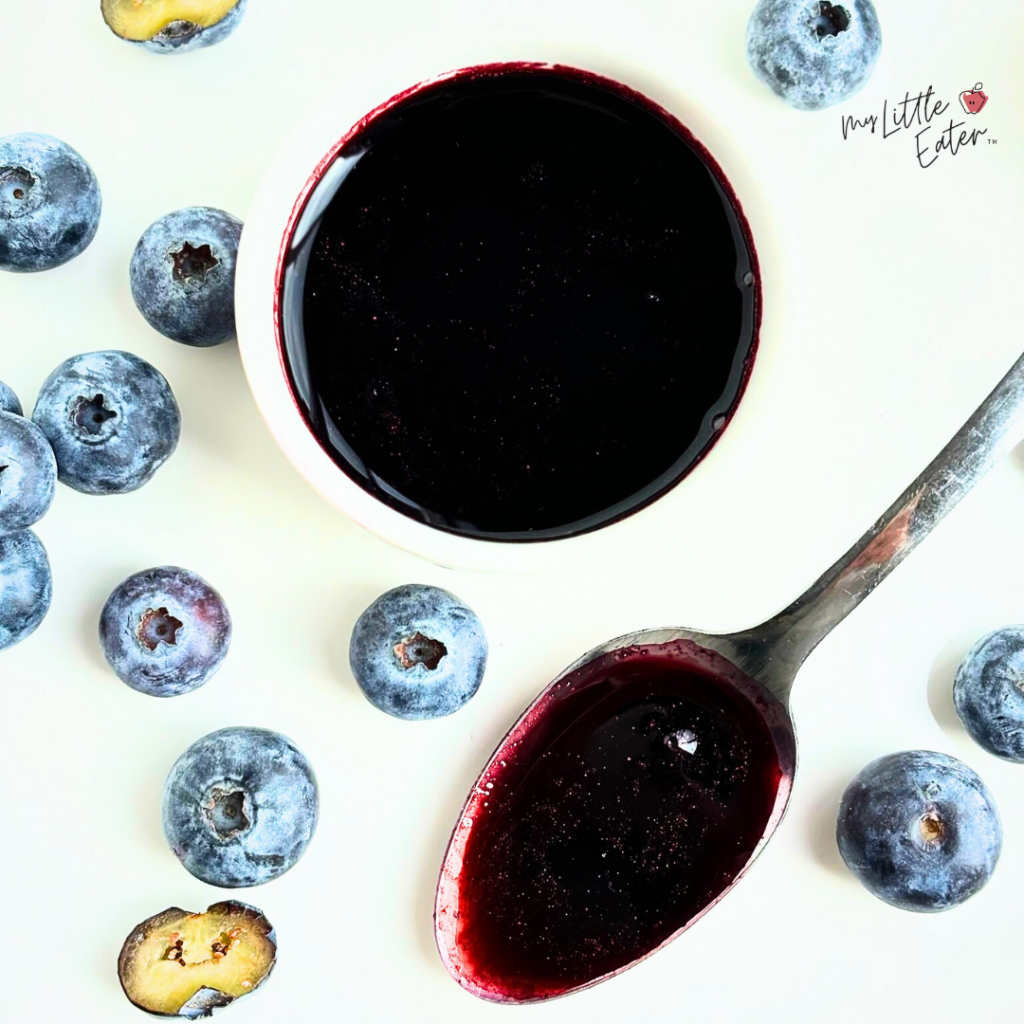 A bowl of dark purple natural food coloring made from fresh blueberries.