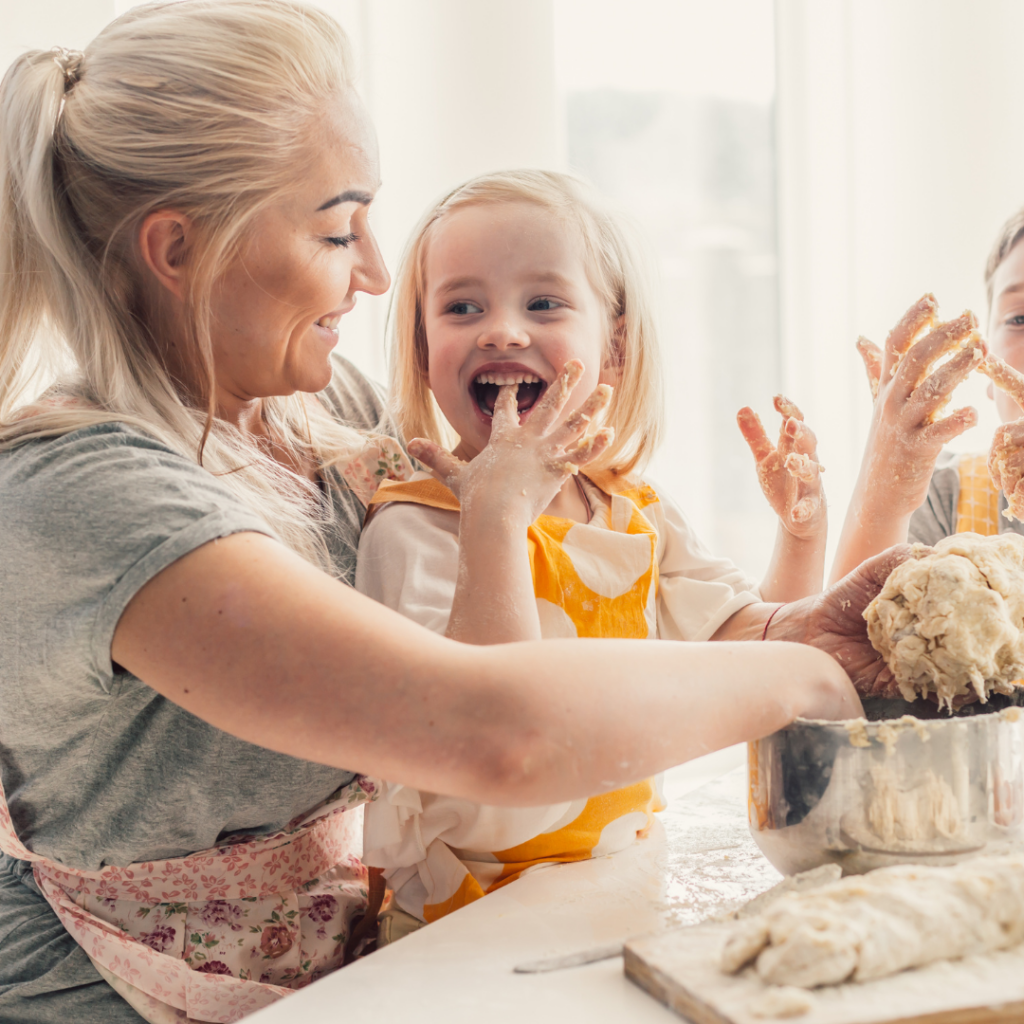 Parent and children baking together and getting messy.