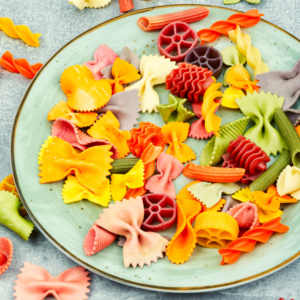 Serving baby pasta of various colors, textures, and shapes for baby led weaning.