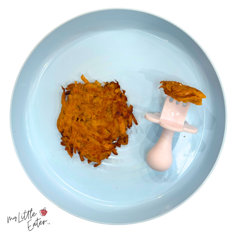 Sweet potato baby food made as a fritter to be served whole or in bite-sized pieces on a baby-safe fork.