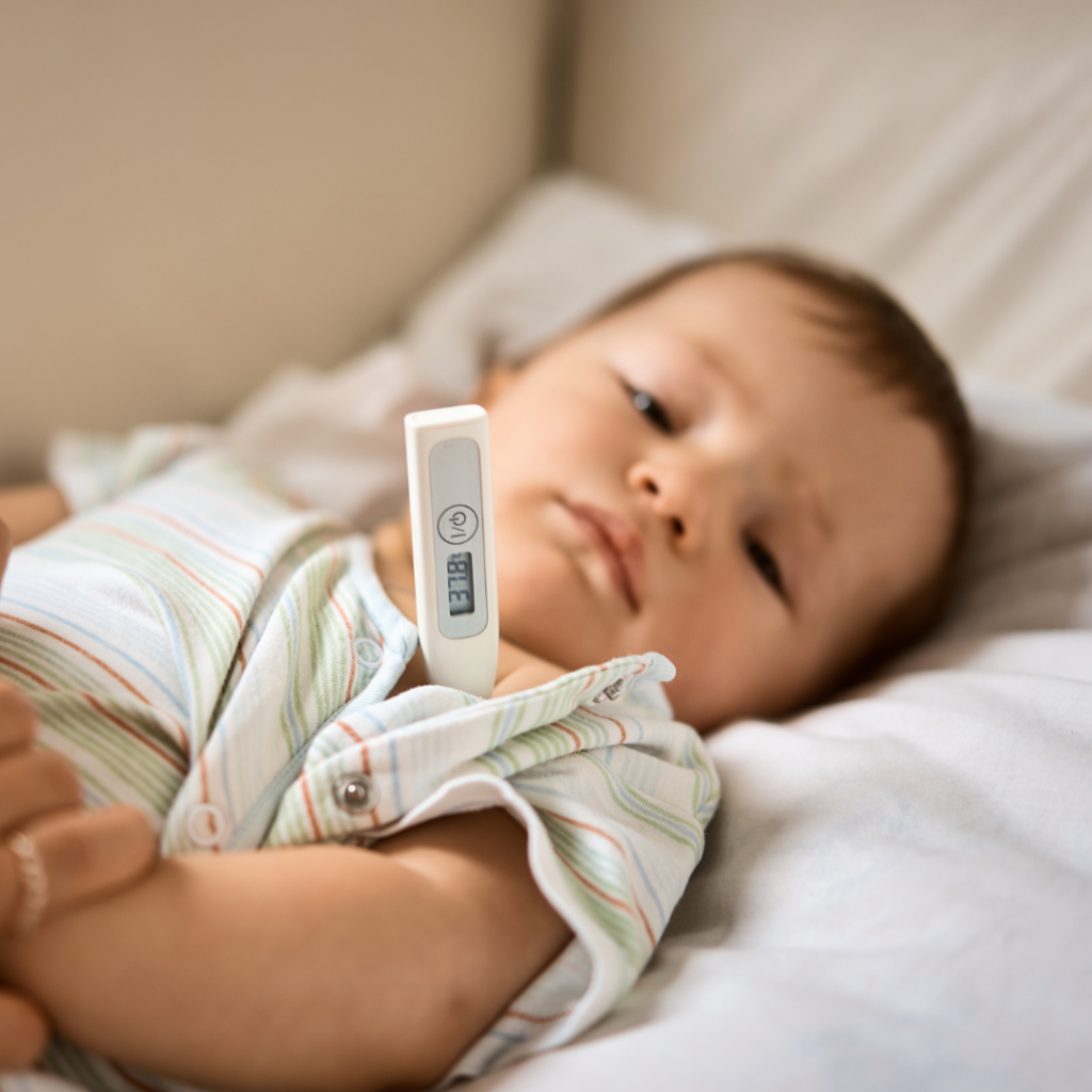 Using a thermometer to check a baby's temperature under their arm.