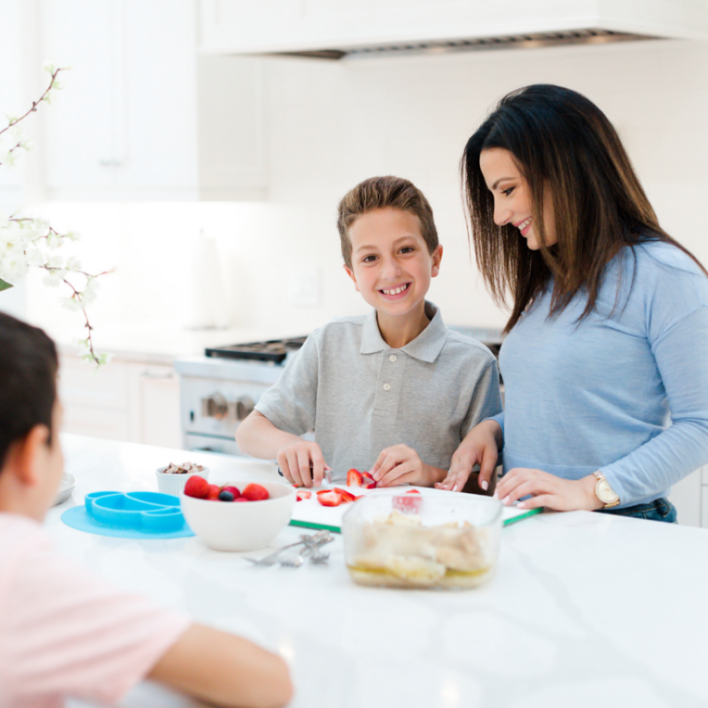 School-aged child using sharp knives to help their parent in the kitchen.