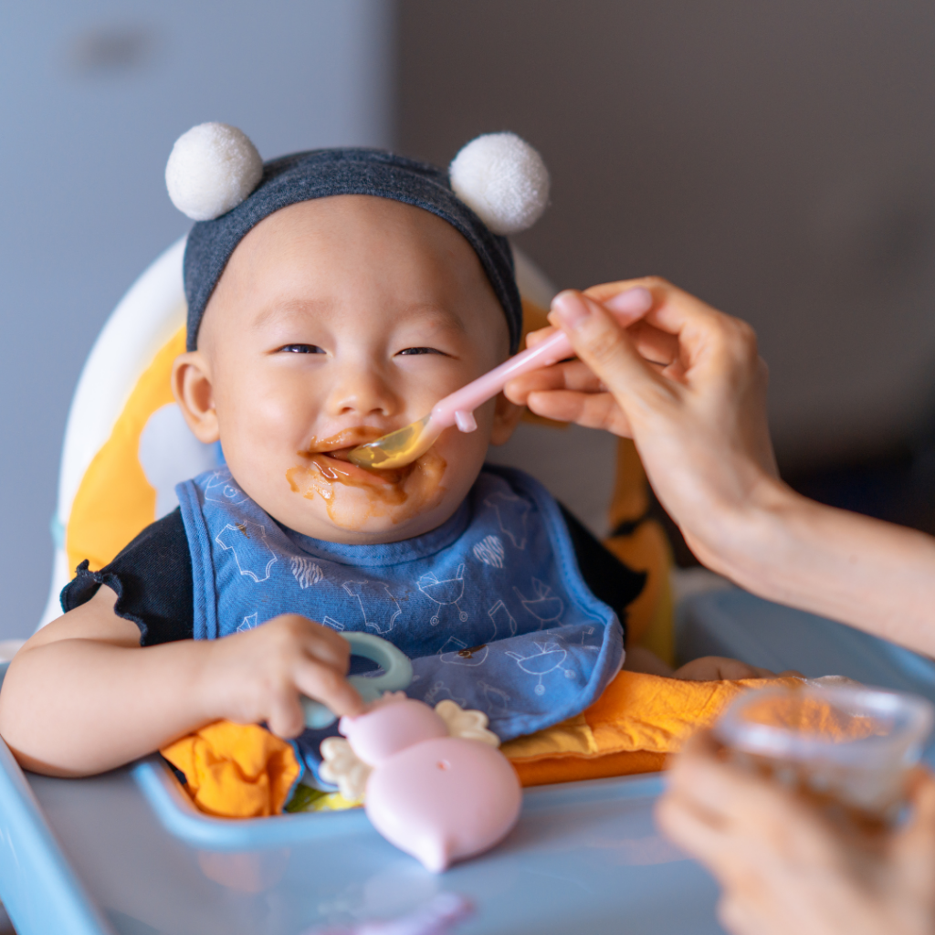 Baby is happily fed purees while seated in their highchair after receiving some teething relief.