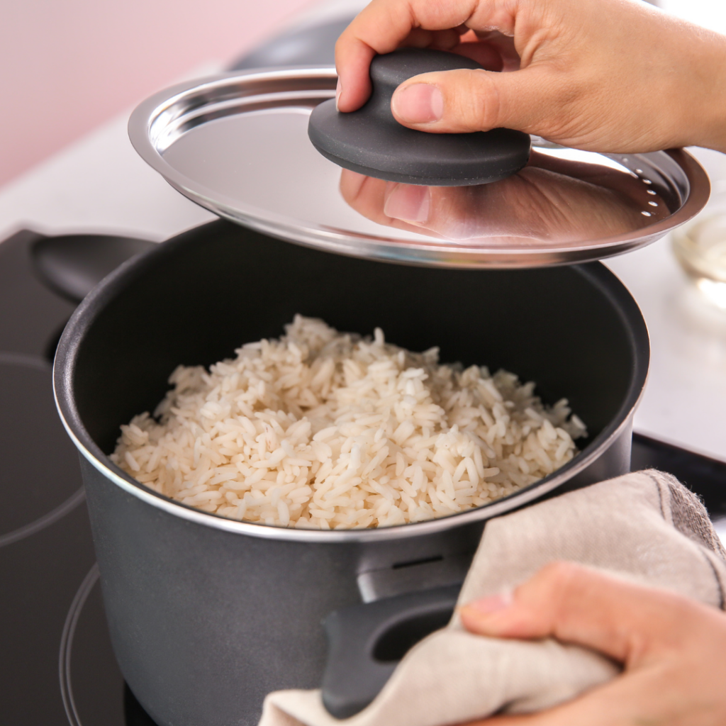 Rice in a pot on the stove, being cooked.