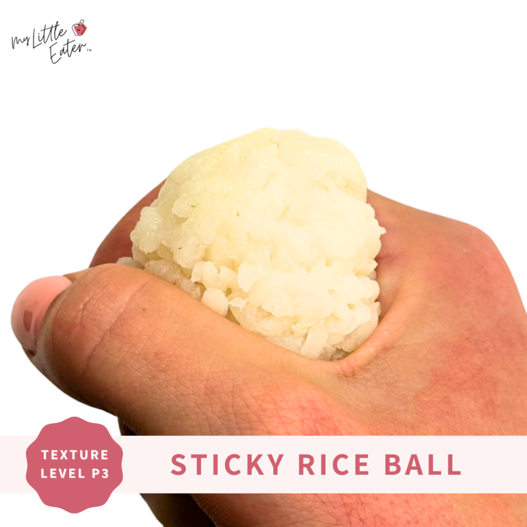 A sticky rice ball being held to show a safe way to offer your baby rice.