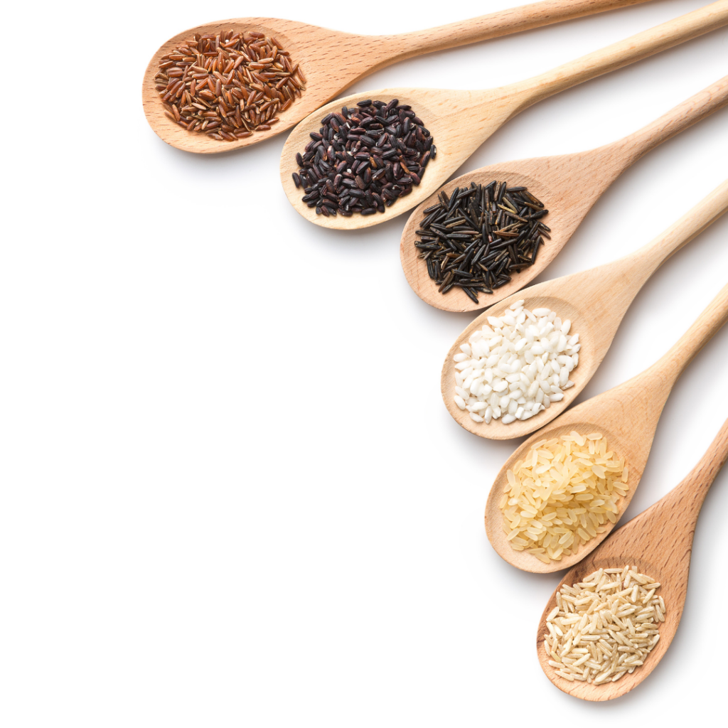 Wooden spoons with various types of dry rice on each one.