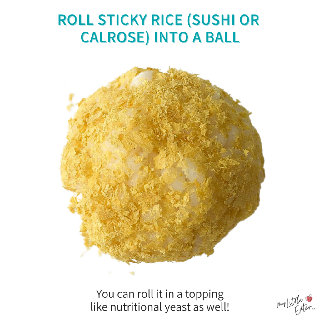 A ball of sticky rice rolled into nutritional yeast.