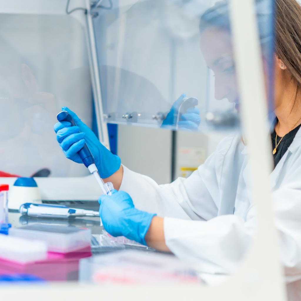 A scientist uses a pipette to fill a test tube.