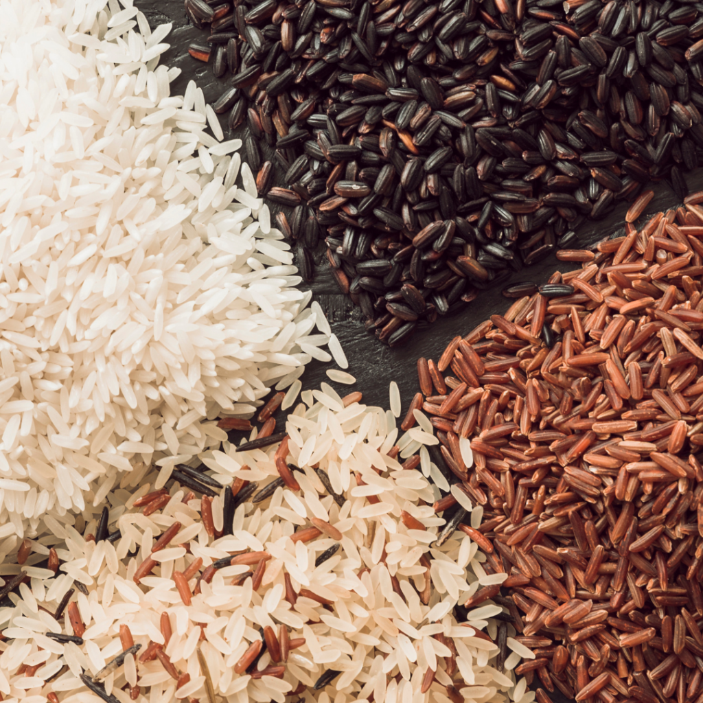 Four types of rice in separate piles.