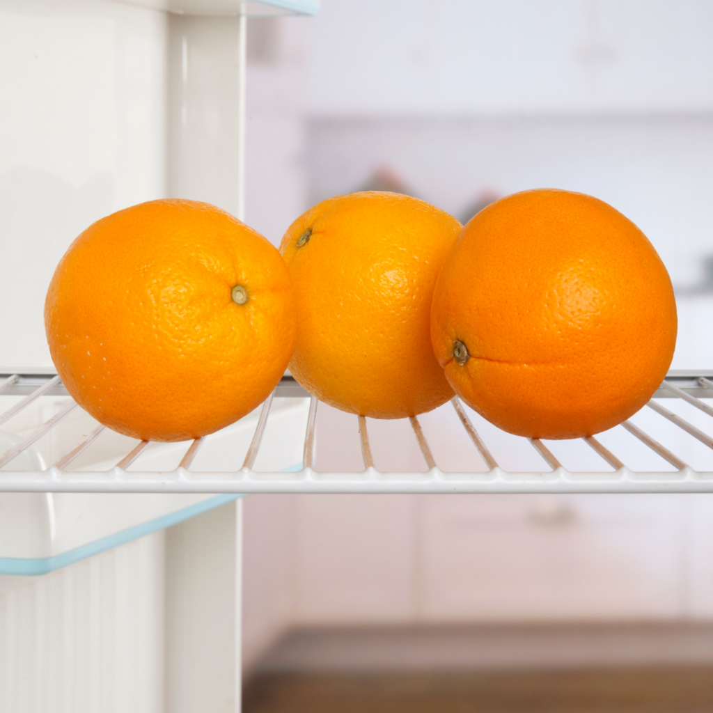 Three oranges for babies stored in the fridge for baby led weaning.