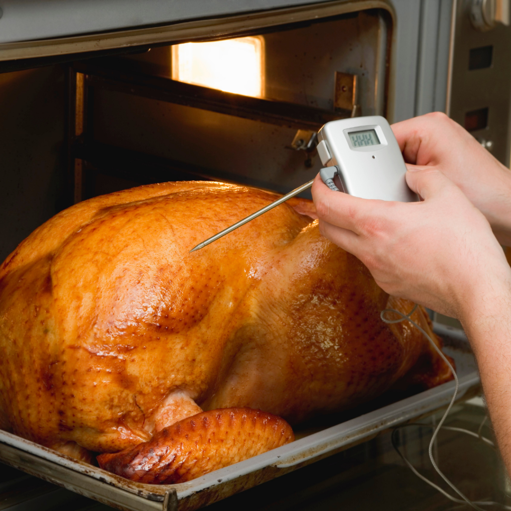 Checking the temperature of a cooking turkey to prevent food poisoning.