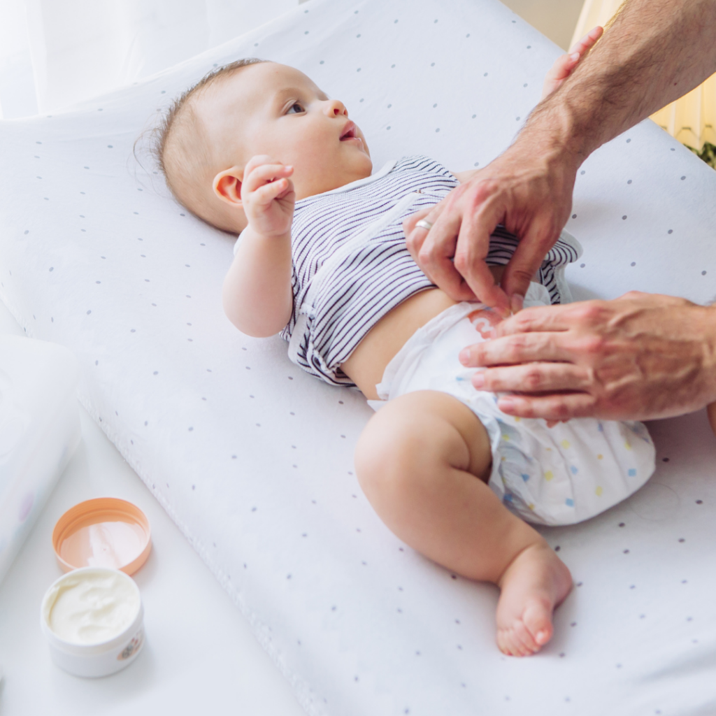 A baby having their diaper changed.