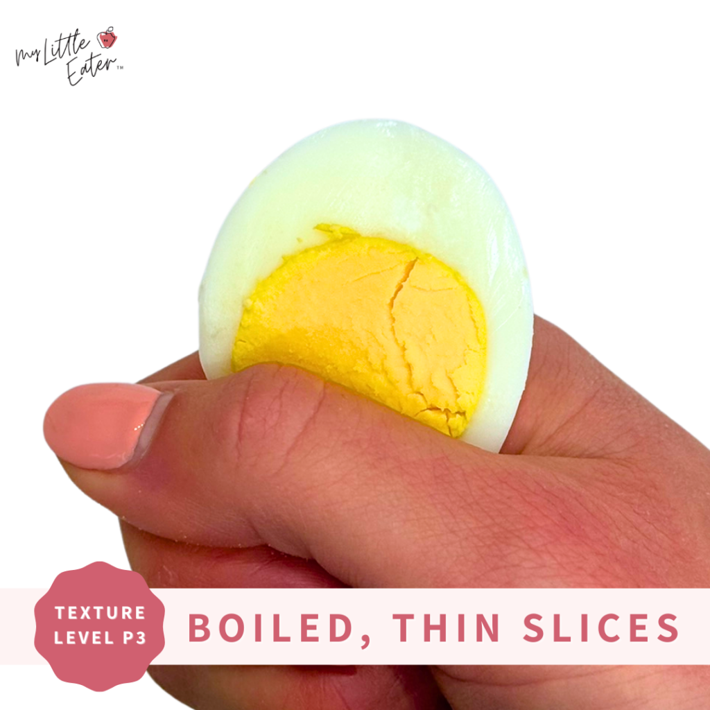 A hard-boiled egg thinly sliced being held in a palmar grasp.