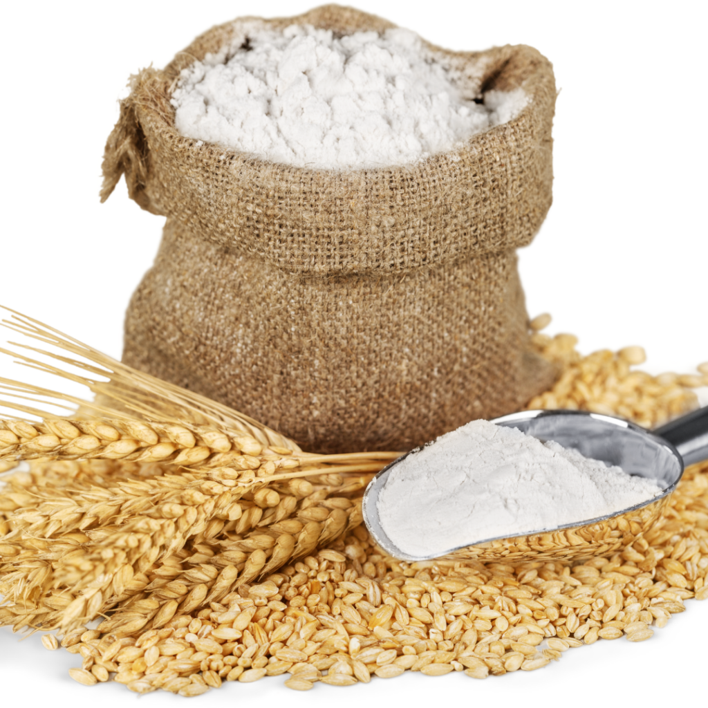 A bag of flour with grains in front of it and a scoop of flour.