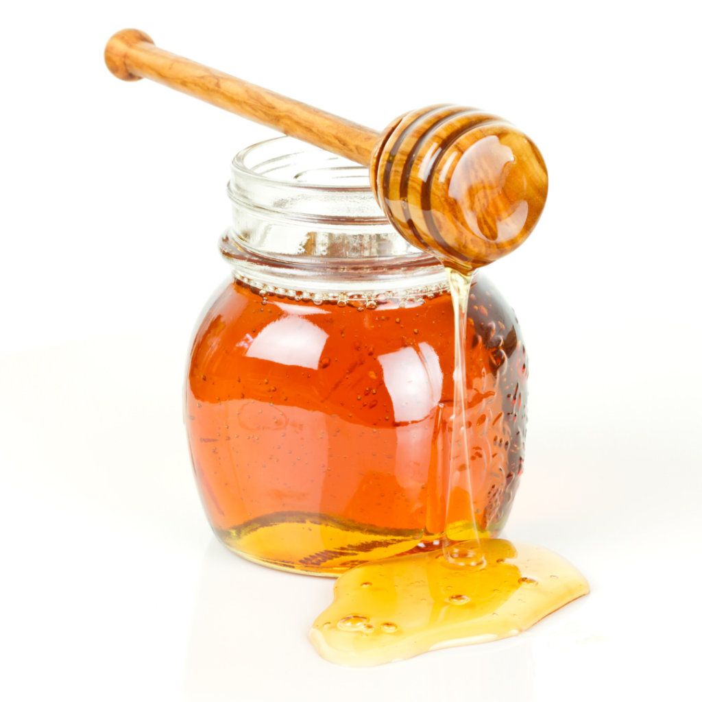 Raw honey in a glass jar.