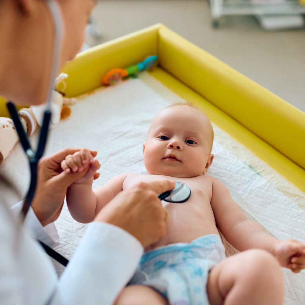 Baby being assessed at an appointment by a doctor due to family history of allergies.