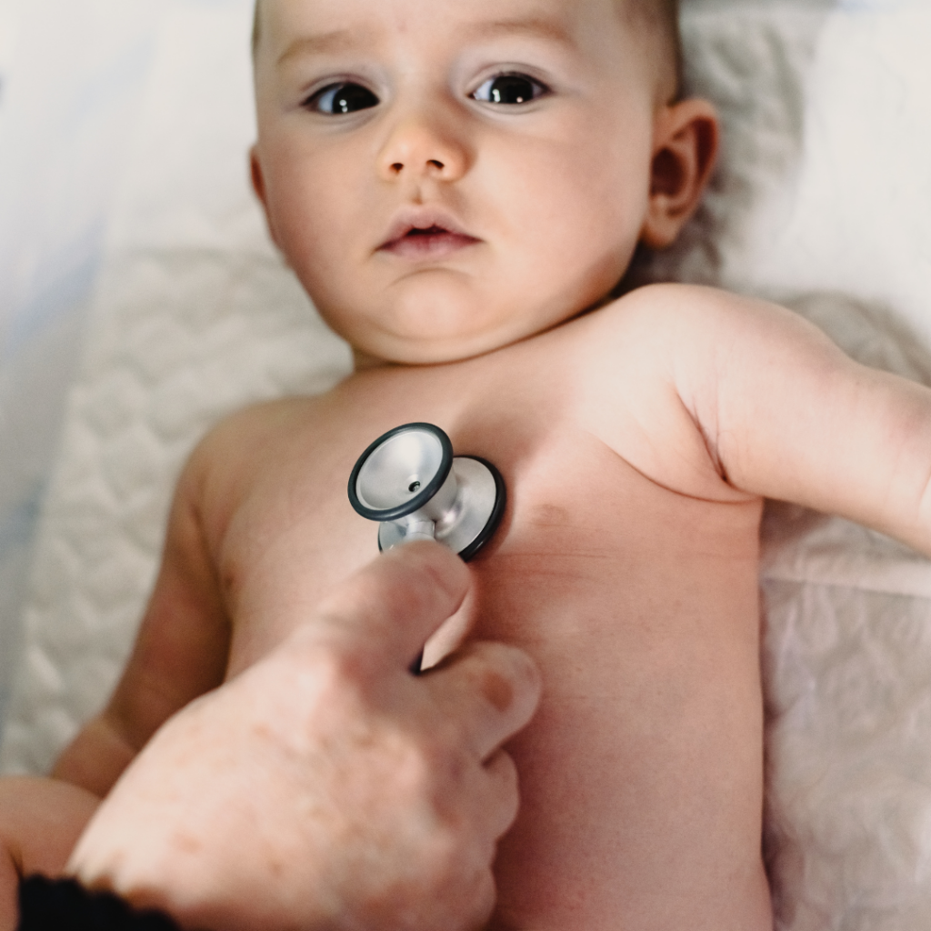 Baby being evaluated by a doctor after parents were feeding eggs to them for the first time.