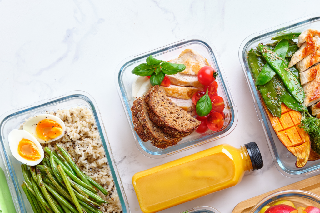 Full meal prep containers and smoothies.