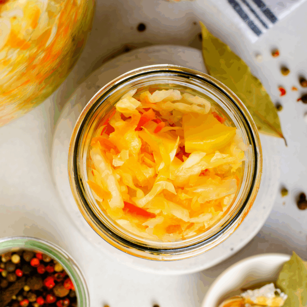 Top few of fermented vegetables in a glass jar.